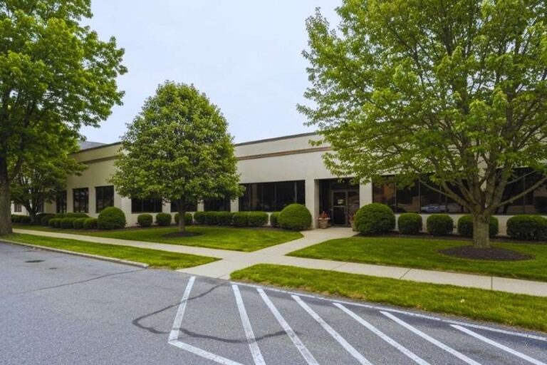 Commercial property grounds care in Nazareth, PA with a neatly mowed lawn, clean entrance walkway, and professional landscape upkeep.