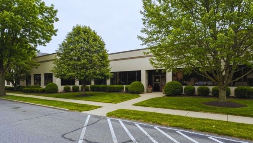 Commercial property grounds care in Nazareth, PA with a neatly mowed lawn, clean entrance walkway, and professional landscape upkeep.
